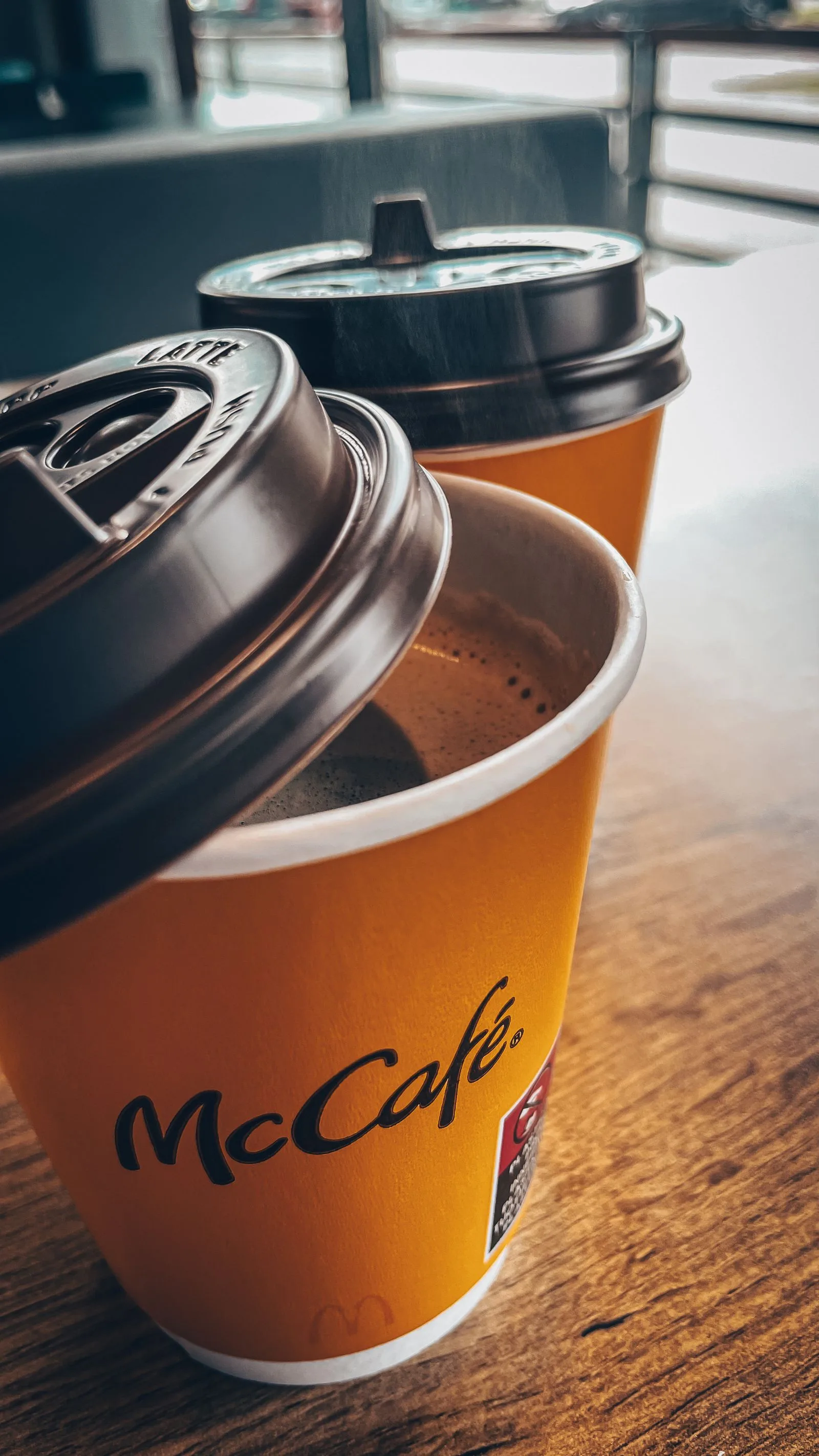 Assorted coffee cups from different coffee brands and chains