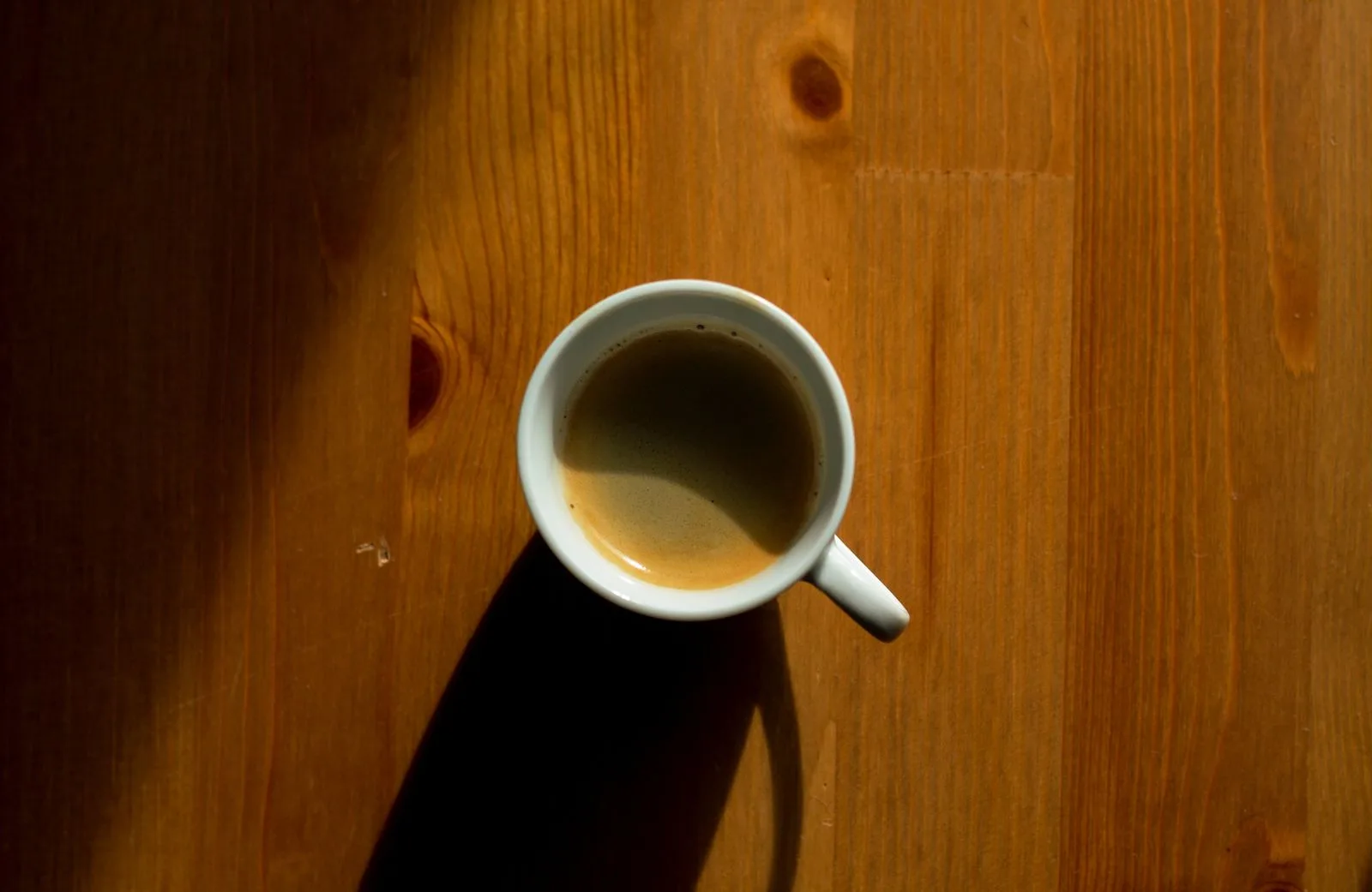 Two small espresso cups filled with dark coffee on a saucer