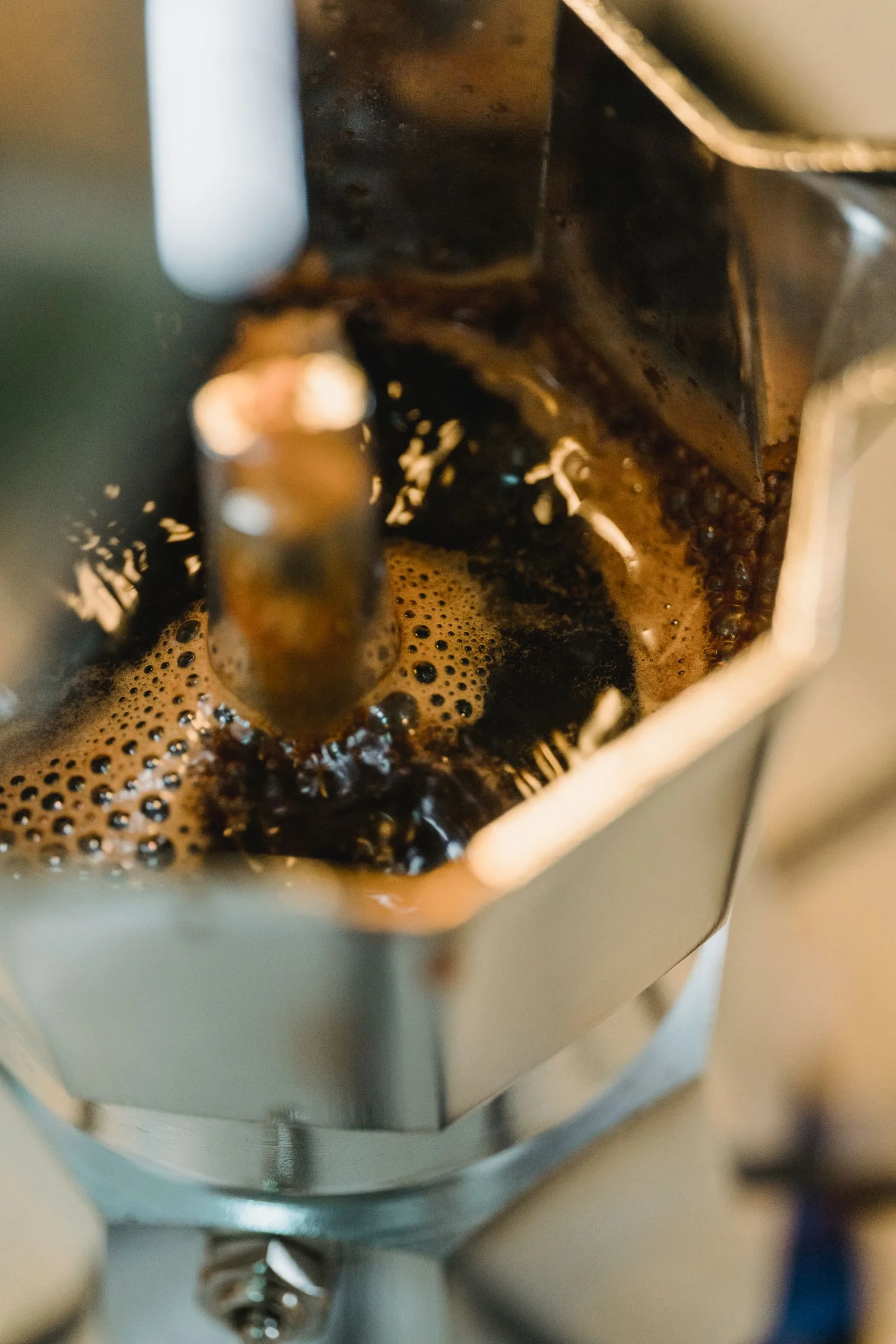 Moka pot stovetop coffee maker heating on stove