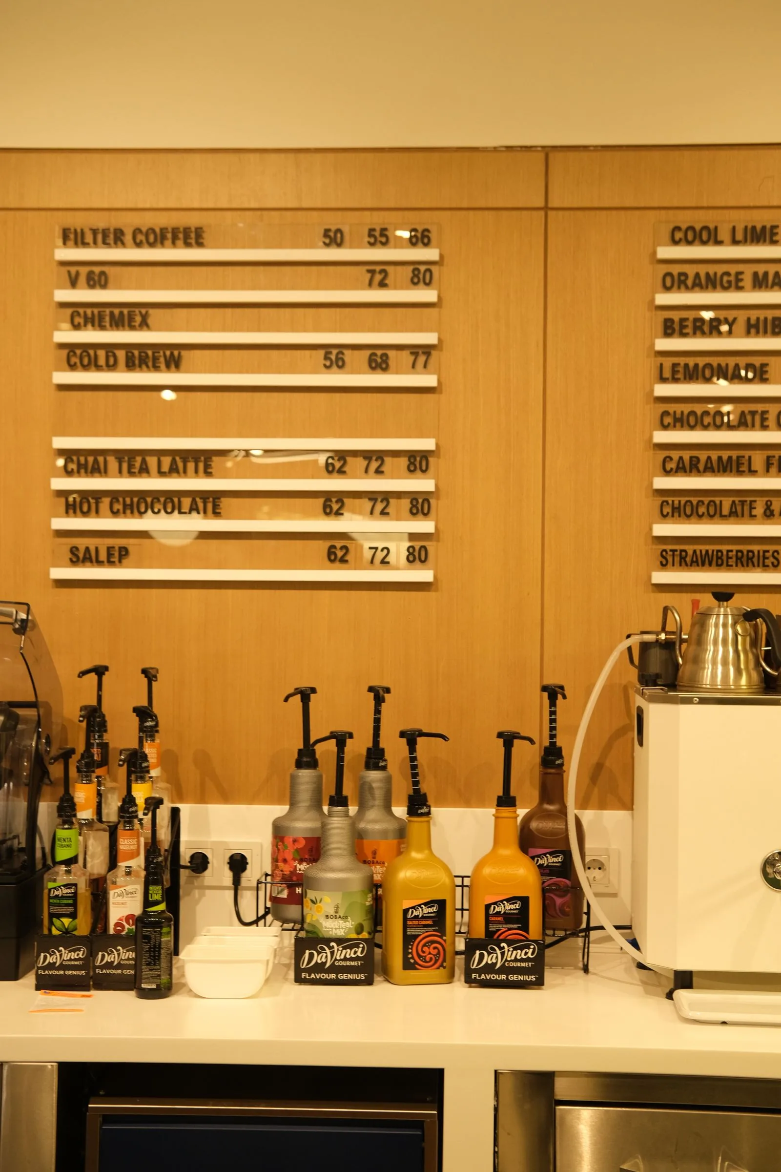 Coffee shop menu board displaying beverage names and prices